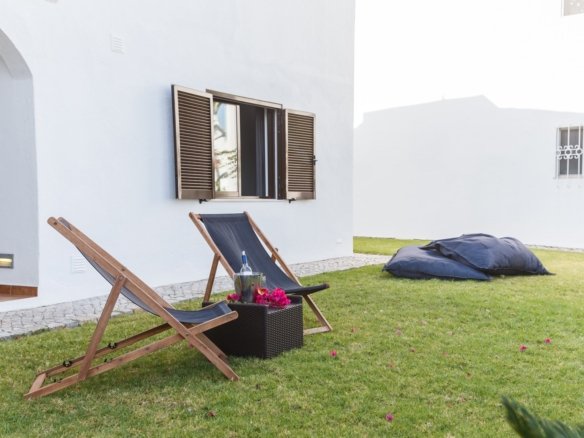 summer apartment garden with chairs and pillows setup Your Gateway to Properties in Laos